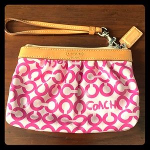 Cute pink and white coach wristlett purse